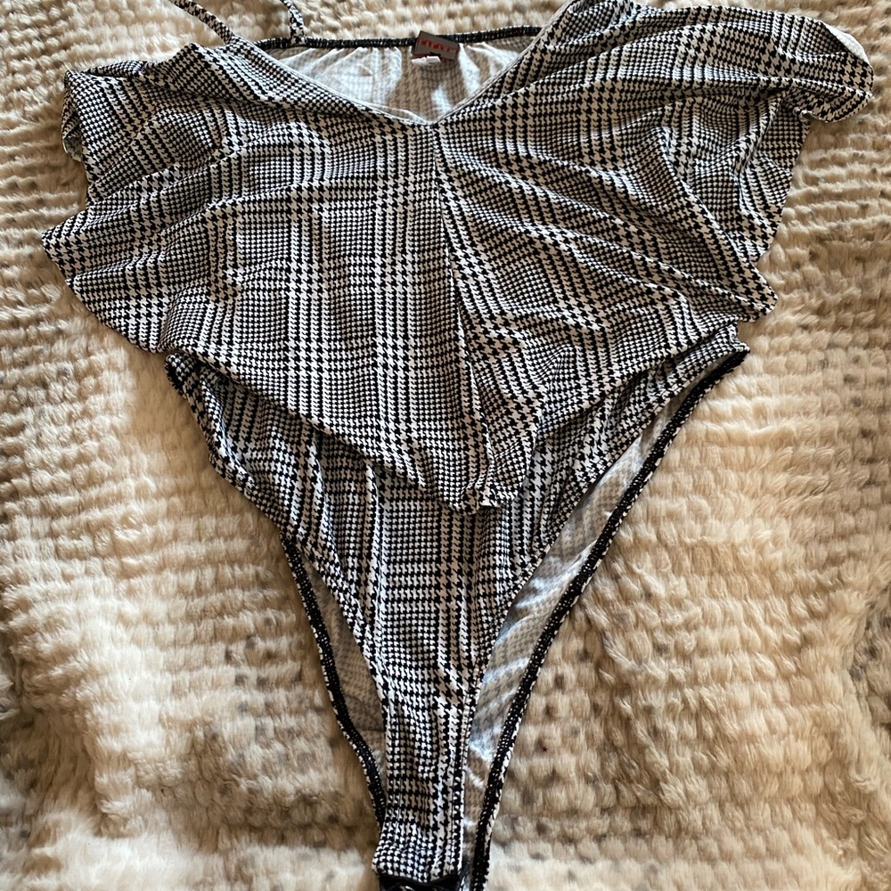 Women bodysuit black and white gently used .